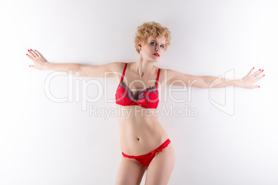 Portrait of hot blonde posing in red lingerie