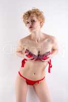 Attractive blonde woman posing in erotic lingerie