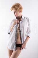 Pretty woman posing in shirt over her naked body