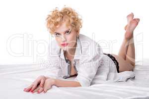 Hot middle aged blonde posing lying on bed