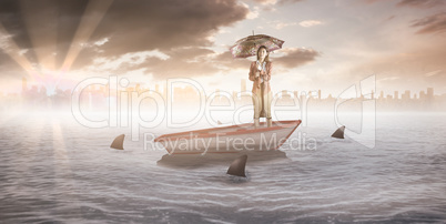 Composite image of businesswoman with an umbrella