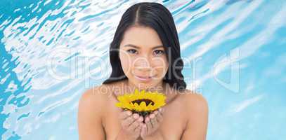 Composite image of natural black haired model holding sunflower
