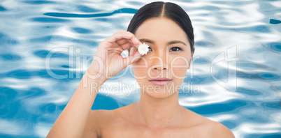 Composite image of sensual black haired model holding white flow