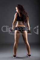 Rear view of sexy female athlete posing in studio
