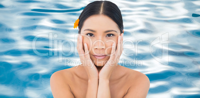 Composite image of sensual model with orange flower in hair touc