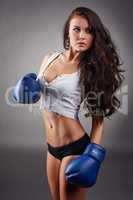 Studio shot of sexy girl in boxing gloves