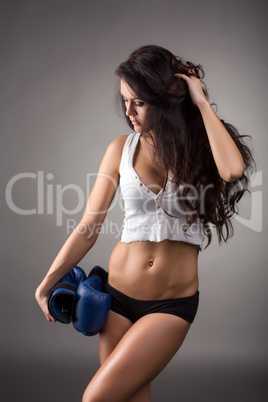 Dark-haired athlete posing with boxing gloves