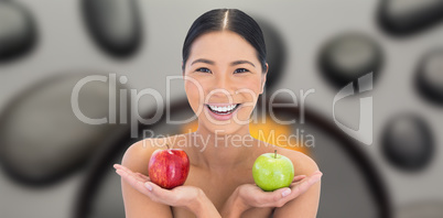Composite image of smiling natural brunette holding apples in bo