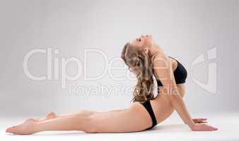 Image of flexible woman doing fitness exercise