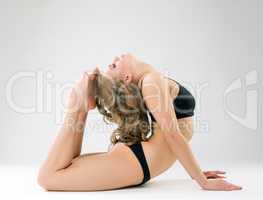 Flexible model posing while doing gymnastic ring