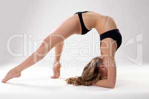Image of flexible woman doing pilates exercises