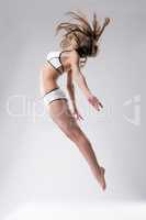Graceful athletic girl posing in jump
