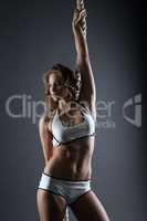 Muscular female athlete posing with rope