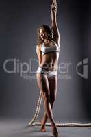 Image of seductive model posing holding on rope