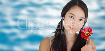 Composite image of smiling woman holding flower