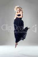 Beautiful blonde dancer posing in jump