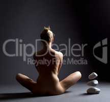 Idea of telekinesis. Naked girl and flying stones