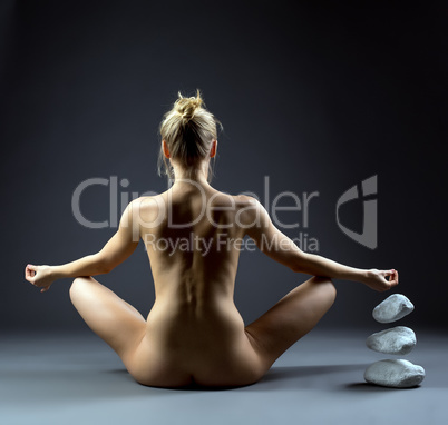 Nude female telekinetic posing back to camera