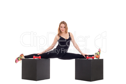 Flexible girl doing gymnastic splits on cubes