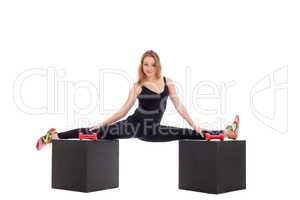 Flexible girl doing gymnastic splits on cubes