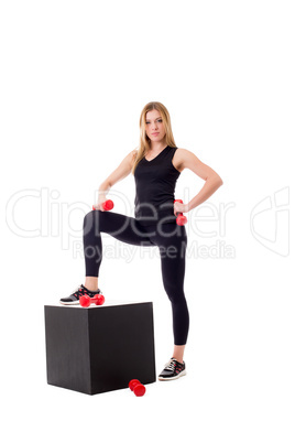 Pretty girl posing in sportswear with dumbbells