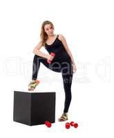 Pretty girl doing pilates exercises at camera