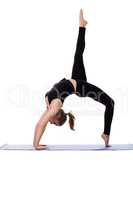 Graceful girl doing gymnastic bridge on mat