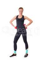 Cute athlete with dumbbells smiling at camera