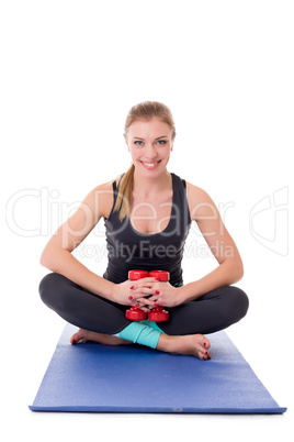 Smiling pilates trainer posing with dumbbells