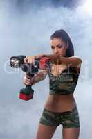 Exciting brunette posing with flashlight and drill