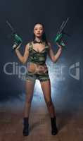 Building as war. Hot woman armed with perforators