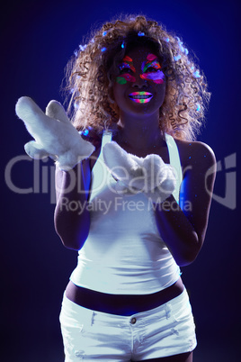 Girl posing with artificial snow under UV light