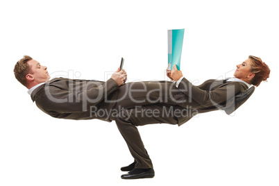 Business people posing in difficult acrobatic pose