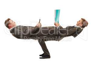 Business people posing in difficult acrobatic pose