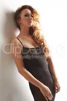 Seductive redhead girl posing in erotic negligee
