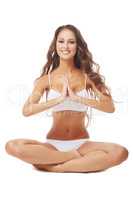 Smiling beautiful brunette posing in yoga pose