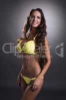 Happy busty woman posing in trendy swimsuit