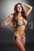 Happy pretty model posing in colorful bikini