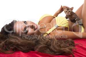Portrait of beautiful model caresses kitten