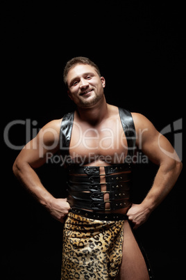 Smiling male dancer dressed as caveman