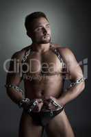 Image of strong male dancer posing with chain