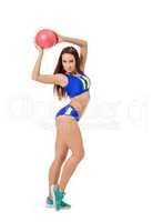 Cute female athlete posing with ball at camera