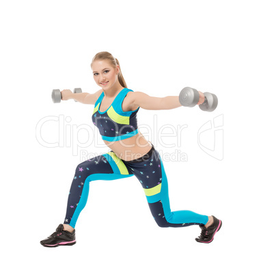 Cute sporty girl posing with dumbbells