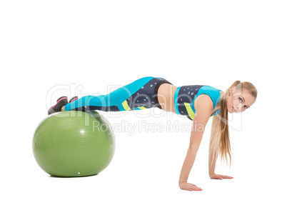 Lovely young girl exercising on fitness ball