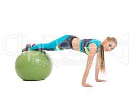 Lovely young girl exercising on fitness ball