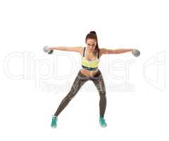 Harmonous girl training with dumbbells at camera