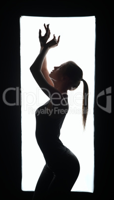 Silhouette of artistic dancer in frame