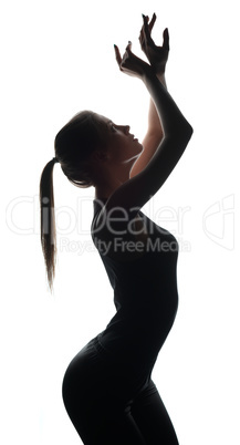 Silhouette of petite dancer posing at camera