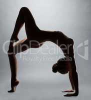 Flexible naked girl doing fitness exercise