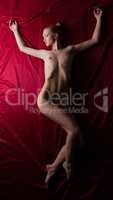 Top view of nude blonde lying on silk sheets